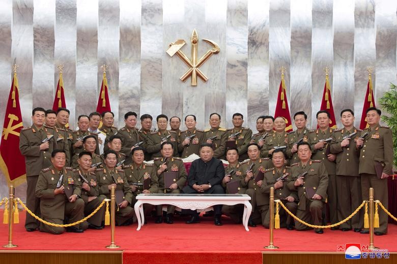 North Korean leader Kim Jong Un poses for a photograph after conferring "Paektusan" commemorative pistols to leading commanding officers of the armed forces on the 67th anniversary of the "Day of Victory in the Great Fatherland Liberation War", which marks the signing of the Korean War armistice, in this undated photo released on July 27 by North Korean Central News Agency (KCNA) in Pyongyang. KCNA via REUTERS